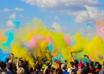 group of people celebrating powder festival outdoors