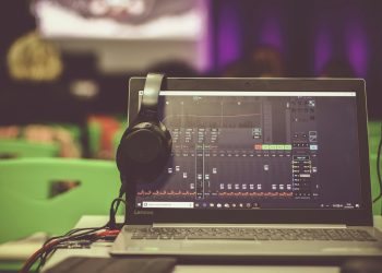 black corded headphones on black and gray Lenovo laptop