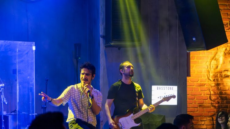 A group of men standing on top of a stage