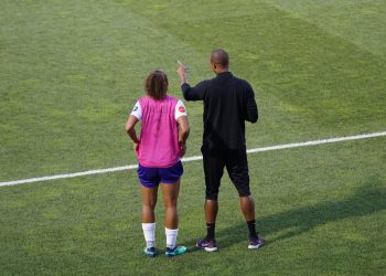 man and woman standing on field