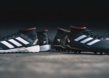 pair of black Adidas cleats