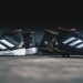 pair of black Adidas cleats